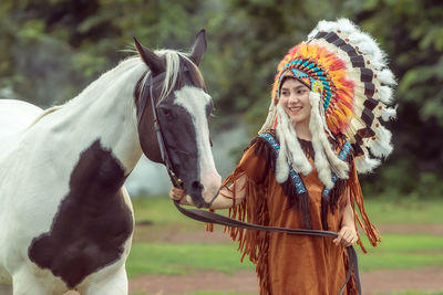 Portrait of young woman with horse