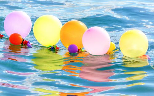 High angle view of colorful balloons against water