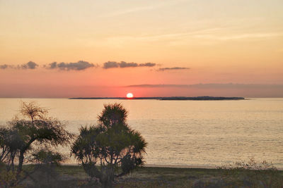 Scenic view of sea against romantic sky at sunset