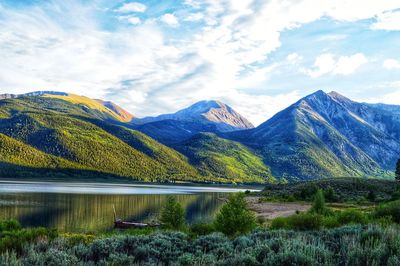 Scenic view of lake and mountains against sky