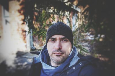 Portrait of young man in park during winter