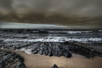 Scenic view of sea against cloudy sky