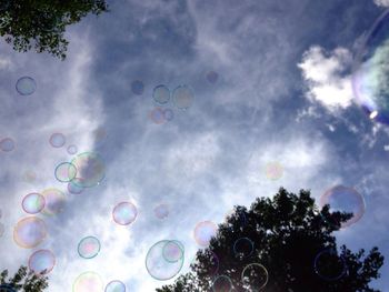 Low angle view of bubbles against sky