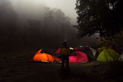 Men enjoy the atmosphere of the forest in the middle of the mountain at night