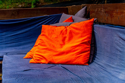 Close-up of orange clothes drying on bed