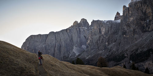 Scenic view of man hiking in mountains