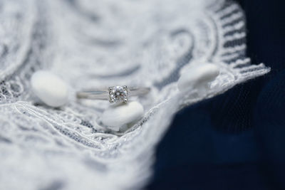 Close-up of wedding ring on fabric