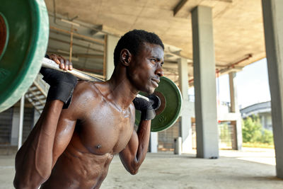 Side view of man exercising in gym