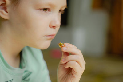 Close-up of young woman applying nail