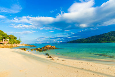 Scenic view of beach against blue sky