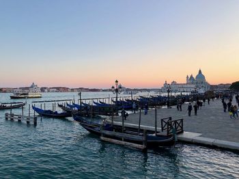 View of boats in sea at sunset