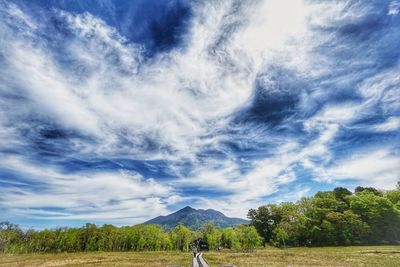 Man standing on field against sky