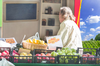 Man standing by fruits at store