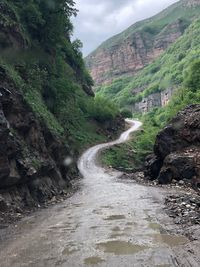 Scenic view of waterfall amidst mountains