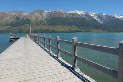 Scenic view of pier and mountains against sky