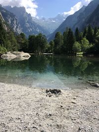 Scenic view of lake and mountains against sky