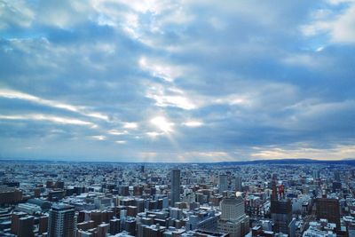 High angle view of city against cloudy sky