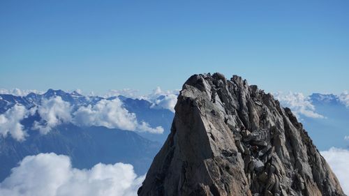 Low angle view of mountain peak, aguille de tour against sky.