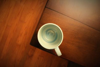 Close-up of coffee cup on wooden table