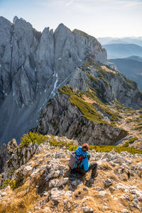 Woman enjoying the view at alpine landscape in autumn, bischofsmütze, annaberg, austria