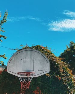 Low angle view of basketball hoop against blue sky