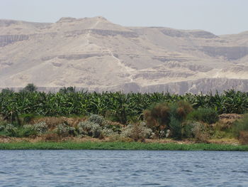 Scenic view of land and mountains against sky