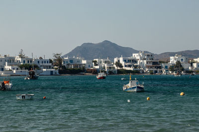 Sailboats in sea against clear sky