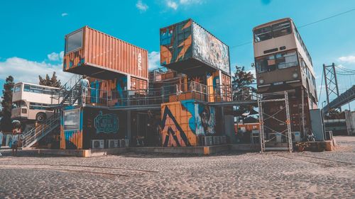 Graffiti on building in city against sky