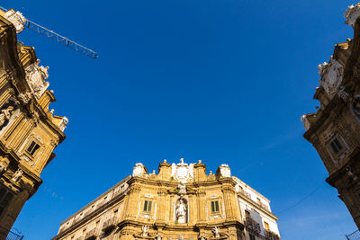 Low angle view of building against blue sky