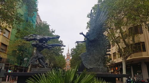 View of statue amidst plants against sky
