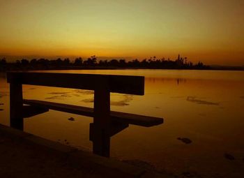 Pier on sea at sunset