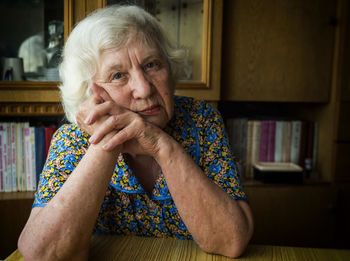 Portrait of woman sitting at home