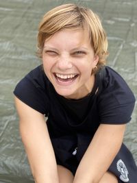 Portrait of smiling man sitting outdoors