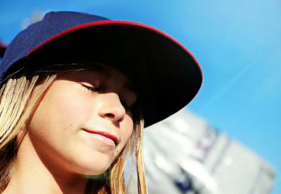 Close-up of beautiful woman against clear sky