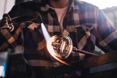 Manual worker making glass at workshop