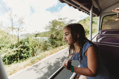 Girl in open air taxi touring usvi in popular cruise port destination