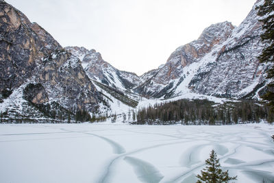 Scenic view of snow covered mountains against sky