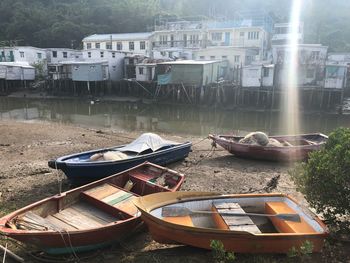 Abandoned boats moored in lake