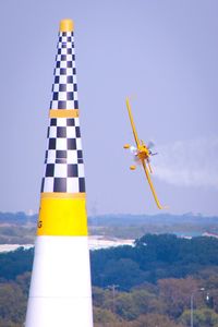 Close-up of yellow balloons against sky