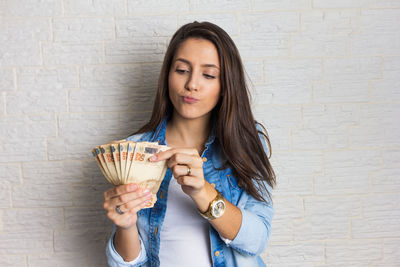 Portrait of smiling young woman using mobile phone