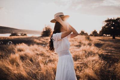 Rear view of woman standing against sky