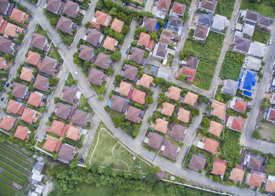 High angle view of road amidst houses on field