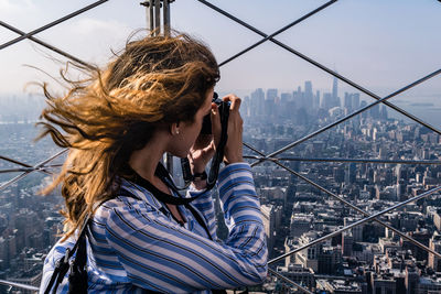 Woman photographing cityscape