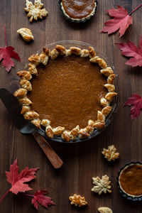 Top down view of a homemade pumpkin pie with a decorative wheat design edge.