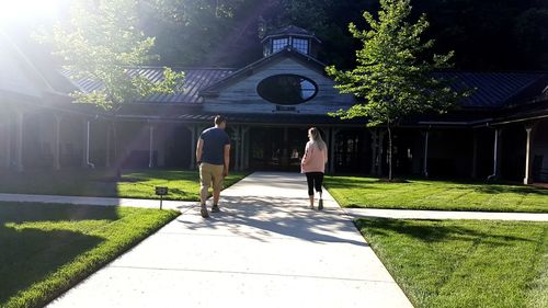 Rear view of people walking on street