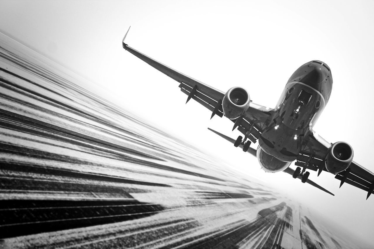 LOW ANGLE VIEW OF AIRPLANE AGAINST SKY