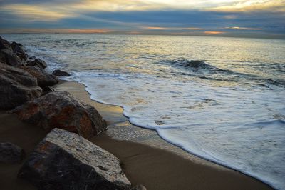 Scenic view of beach against sky during sunset