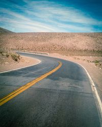 Empty road along trees