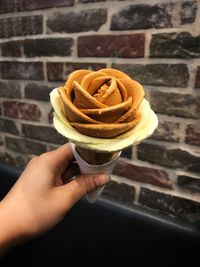 Close-up of hand holding ice cream