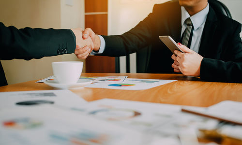 Close-up of business colleagues working in office